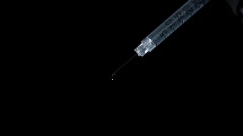 Medicine drop falling from an injection in slow motion Stock Footage 81230343