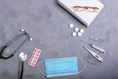 Medicine instruments, tablets on a grey background. Top view Stock Photos