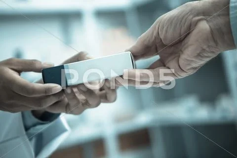 Medicine pack being handed to someone Stock Photos