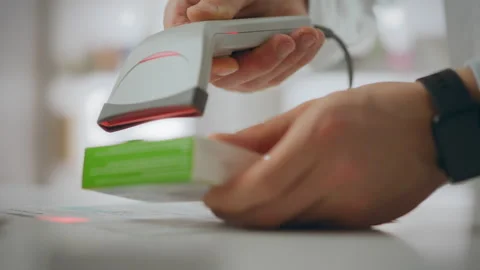 Medicine. A pharmacist uses an electronic scanner to dispense medications at Stock Footage 331287277