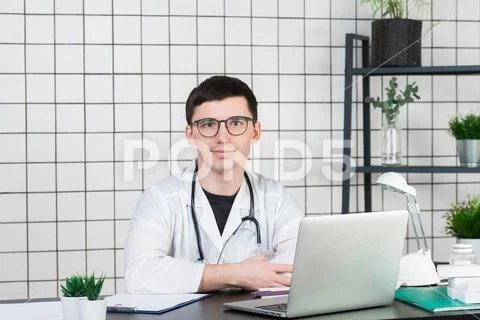 Medicine, profession, technology and people concept - smiling male doctor with Stock Photos