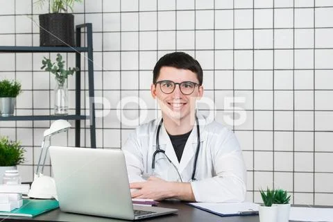 Medicine, profession, technology and people concept - smiling male doctor with Stock Photos