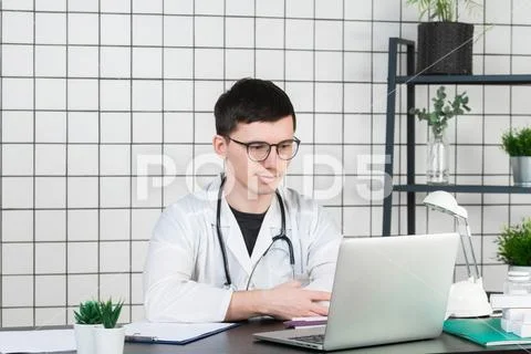 Medicine, profession, technology and people concept - smiling male doctor with Stock Photos