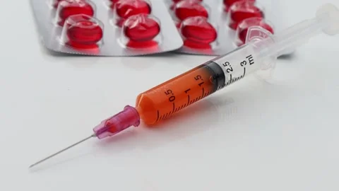 Medicine Red round tablets in a packaging Stock Footage 179066164