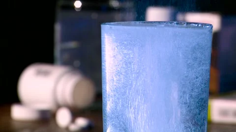 The medicine tablet is dissolved in a glass of water. Stockbeeldmateriaal 145256653