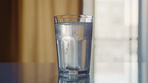 Medicine Tablet Dissolving with Bubbles in Drinking Glass 库存影片 332888631