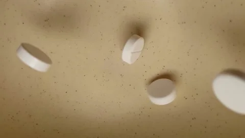 Medicine tablets falling into a ceramic bowl in slow motion Stock Footage 135409571