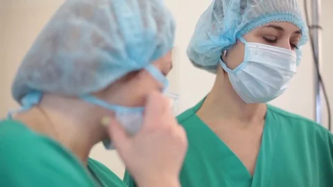 Medicine. two young nurses stand in the operating room and communicate Video stock 70807144