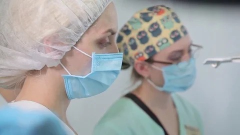 Medicine. Two young students look at how surgery is performed Video stock 76016877