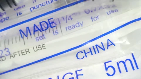 Medicine. A very close up of a collection of hypodermic syringes made in China. Stock Footage 190455748