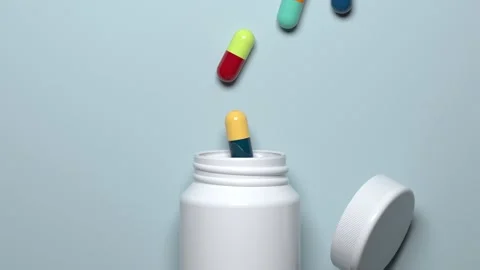 Medicines, multi-colored capsules pour out of the jar and fall asleep back  Stock Footage 131067183