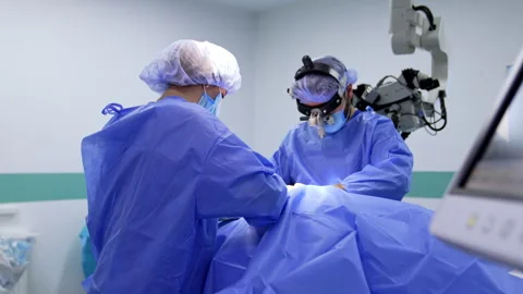 Medics cover the patient lying on the operating table with blue sheet. Stock Footage 333336895