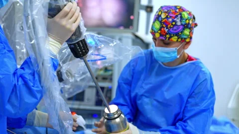 Medics deal with modern robotic system. Robotic arm is cleaned by the nurse. Stock Footage 335167684