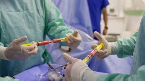 Medics getting ready for stem cell operation. Doctors mixing blood plasma  Stock Footage 217432821