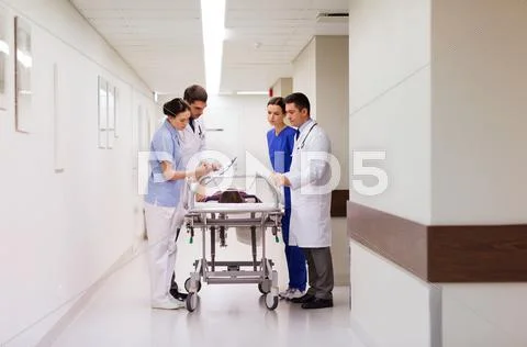 Medics with woman on hospital gurney at emergency Stock Photos