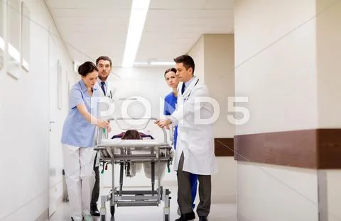 Medics with woman on hospital gurney at emergency Stock Photos