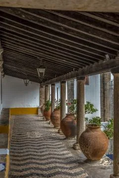 Medieval arcade view with orange ceramic vases and antique granite columns Stock Photos