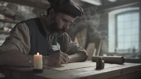 A medieval artist drawing a line segment and writing letters with a quill pen Stock Footage 338994504