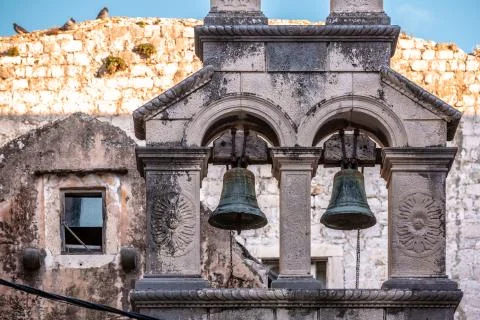 Medieval bell tower top with rusty bell cote Stock Photos