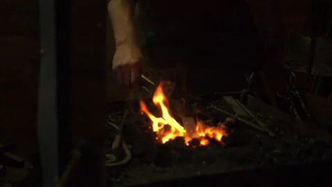 Medieval Blacksmith Working with Molten Metal Stock Footage 264671770