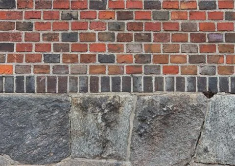 Medieval brickwork on stone foundations. Stock Photos