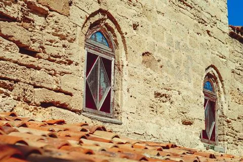 Medieval building with old windows Stock Photos