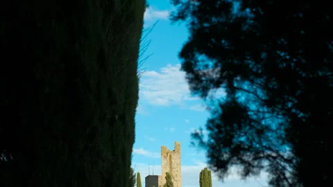 Medieval castle emerging from behind cypress trees in tuscany Stock Footage 318655438