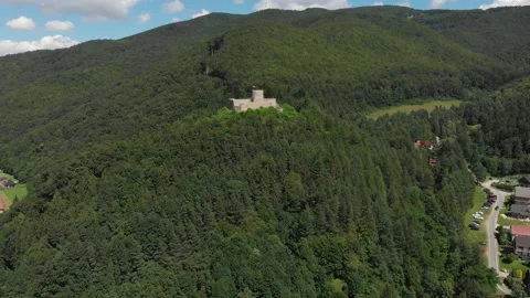 Medieval castle at forested mountains background in summer Stock Footage 141364986