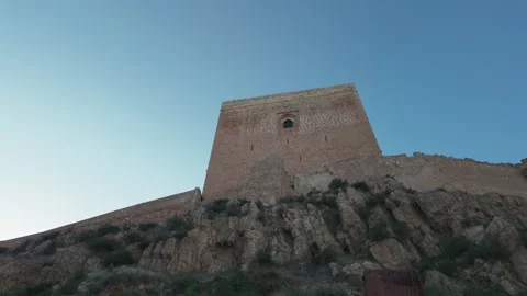 Medieval Castle of Lorca Fortress Tower Against a Clear Blue Sky Stock-Footage 338281773
