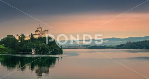 Medieval Castle on the mountain by the lake. Stock Photos