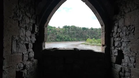 Medieval Castle Stone Window Arch Looking Out to River and Forest Stock Footage 345865760