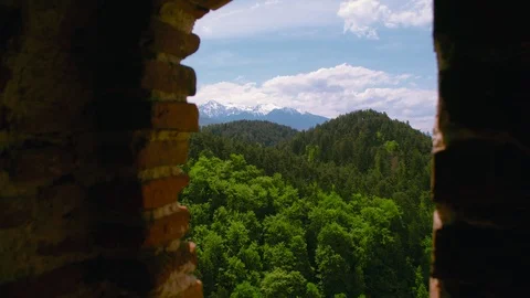 Medieval castle window to awesome landscape of mountains with snow Stock Footage 107931199