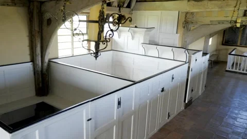 Medieval church interior. Elevated pan of aisle, pews and altar Thomas Beckett Stock Footage 243607771