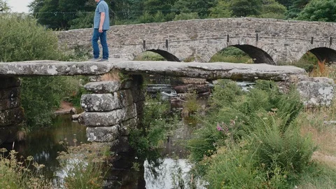 Medieval clapper bridge Postbridge Dartmoor Stock Footage 129758842