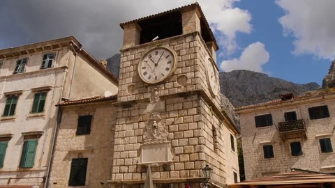 Medieval clock tower in old city of Kotor, Montenegro. Tilt up shot Stock Footage 83123339