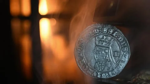 Medieval coin, candlelight in the background, and smoke. Stock Footage 332443910
