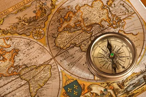 Medieval compass on an ancient world map Stock Photos