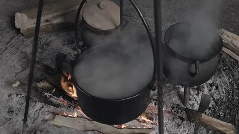 Medieval cooking pot heating over an open fire Stock Footage 320250368