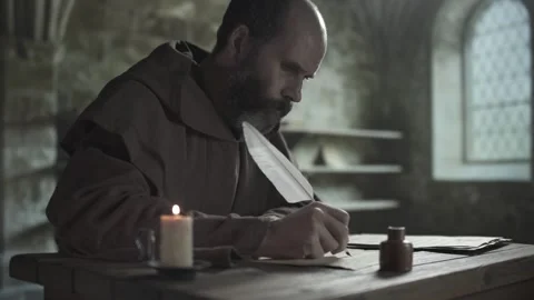 Medieval copyist copying a manuscript with a long quill next to scrolls on table Stock-Footage 340502602