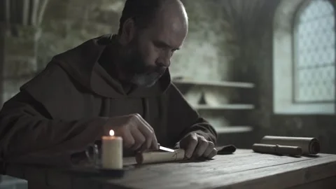 Medieval copyist cutting a cord on a scroll and rolling out a record sheet Stock Footage 337930038
