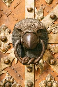 Medieval door knocker in eagle contour Stock Photos