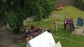Medieval event with people at white tent high angle shot 4k or 4k+ Resolution