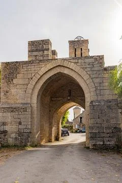 Medieval fortified gateway with pointed stone arch and battlements, Yonne, .. Stock Photos