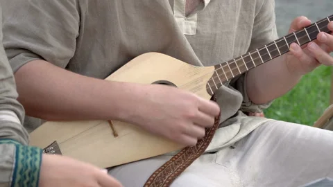 Medieval game plays a melody on a stringed instrument. Stock Footage 106435907