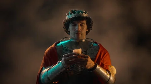 Medieval King in Armor Holding Burning Candle for Prayer Stock Footage 345515947