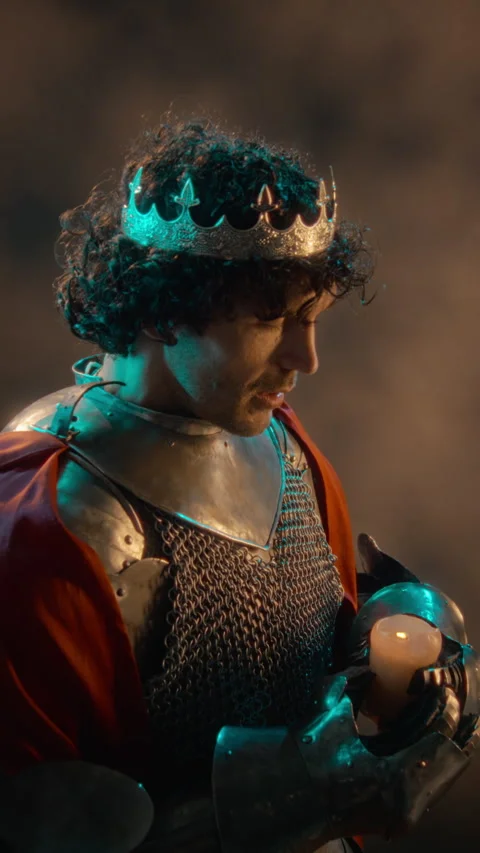 Medieval King in Armor Holding Burning Candle in Darkness Stock Footage 345521569