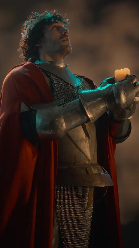 Medieval King in Armor Holding Lit Candle for Historical Drama Stock Footage 345518446