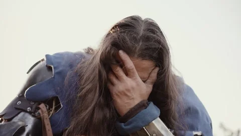 Medieval knight covers his face with his hand and cries Stock Footage 277281172