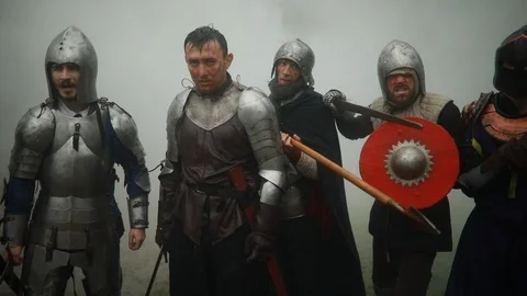 Medieval knights stand with their swords and shields preparing to attack. Stock Footage