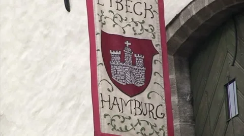 Medieval looking banner hanging on old building in Tallinn Stock Footage 52090193